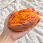 Baked Sweet Potato Squishy, Slow Rising PU, held toward the camera, first-person view