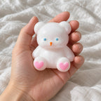 Teddybeer squishy, wit met hartjespootjes, 7 cm, naar de camera gehouden, vanuit eigen perspectief
