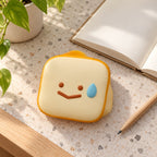Toast squishy kawaii (Smiley toast), on a desk with a notebook and pencil