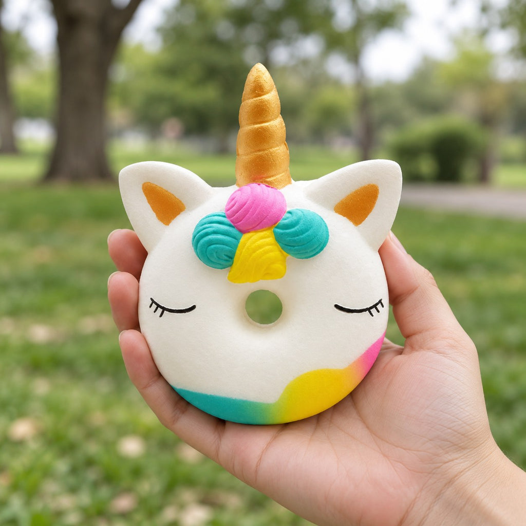 Unicorn Donut Squishy, Slow Rising and Scented, held in a hand to show the real size