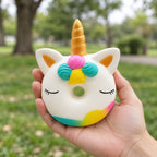 Unicorn Donut Squishy, Slow Rising and Scented, held in a hand to show the real size