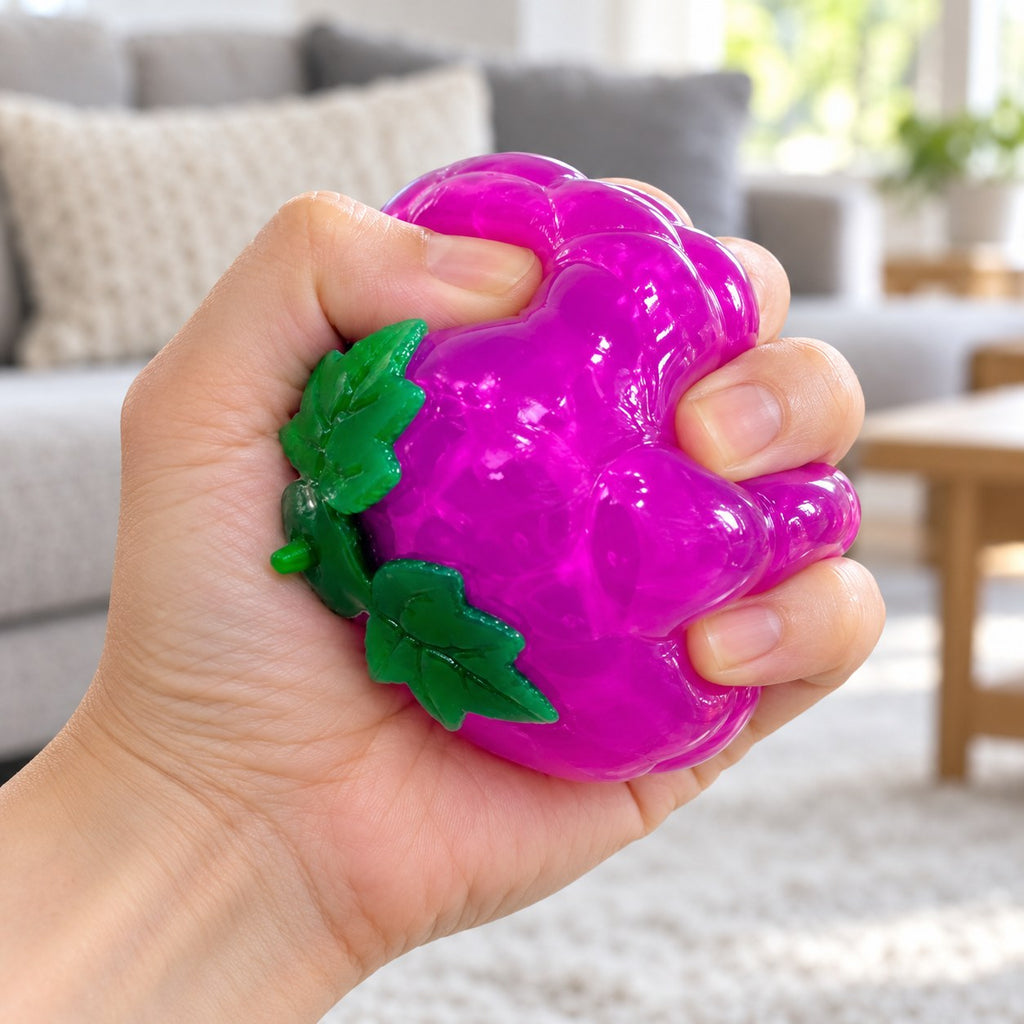 Water Squishy Fruit Ball, Tomato, Grape or Lemon, being squeezed by hand, soft and squishy