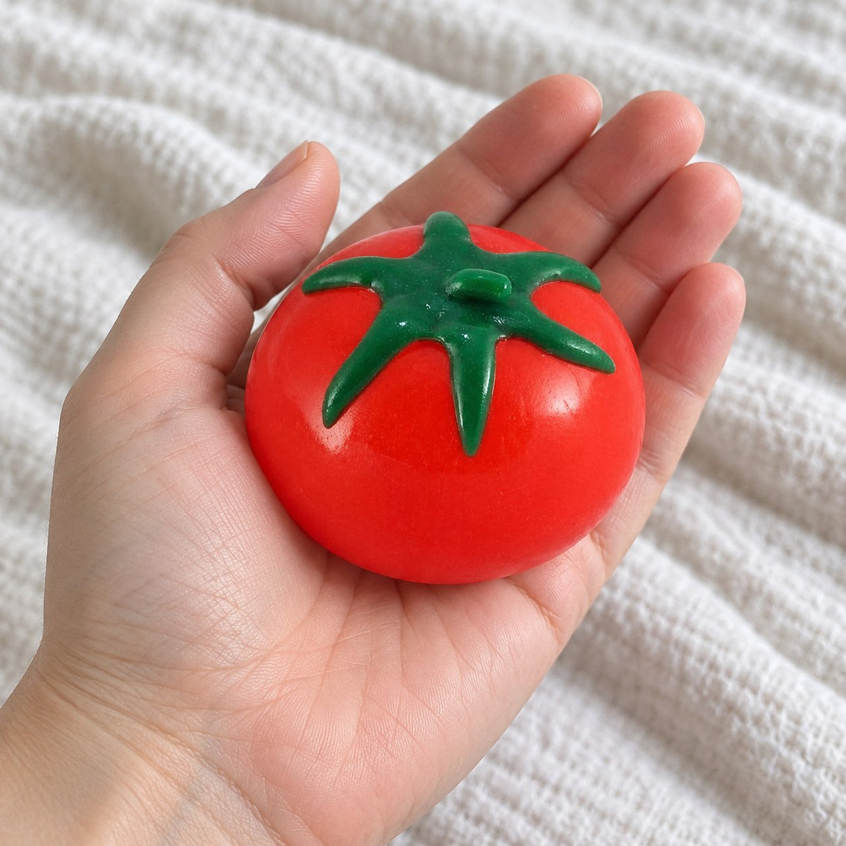 Water Squishy Fruit Ball, Tomato, Grape or Lemon, held toward the camera, first-person view