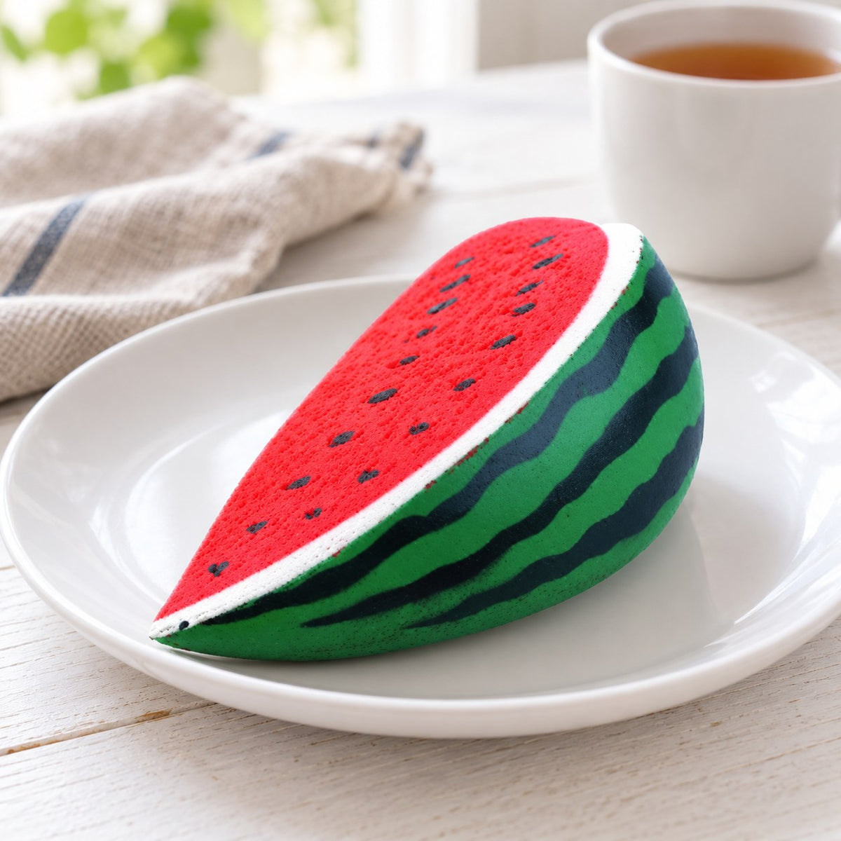Watermelon Squishy, Slow Rising PU, on a plate on a breakfast table