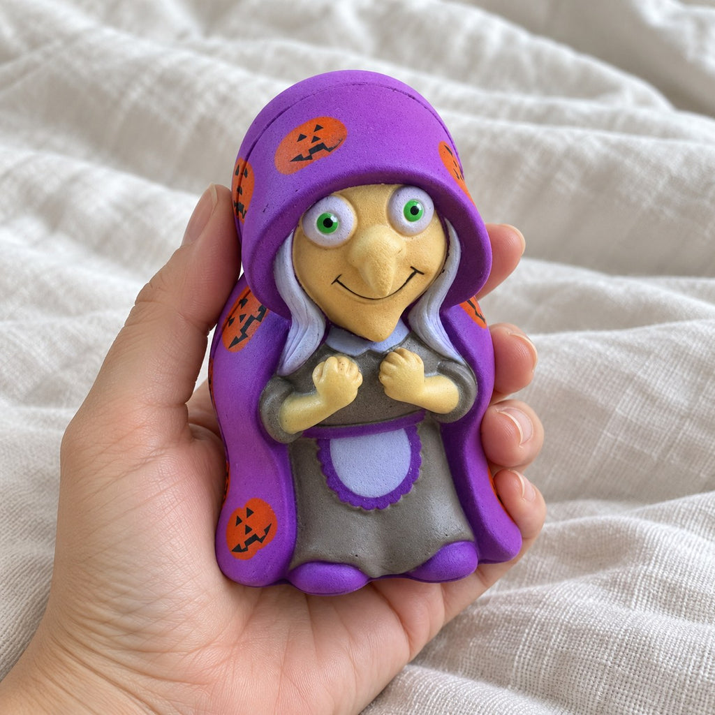Witch squishy halloween, held toward the camera, first-person view