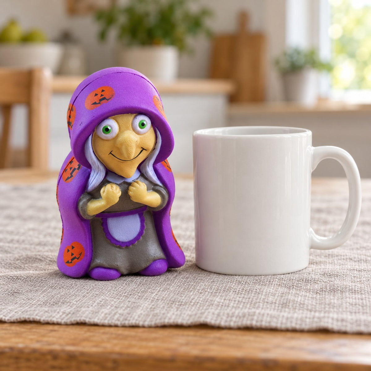Witch Squishy for Halloween, Slow Rising, next to a coffee mug for size comparison